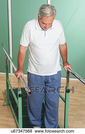 Stock Photo - Mature man rehabilitating his legs. Fotosearch