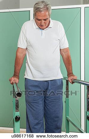 Stock Photo - Mature man rehabilitating his legs. Fotosearch
