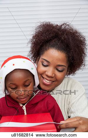 Mother and daughter preparing Christmas gifts View Large Photo Image Picture - Mother and daughter preparing Christmas gifts. Fotosearch