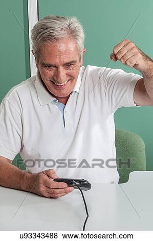 old man having fun with videogames View Large Photo Image Stock Photo - old man having fun with videogames. Fotosearch