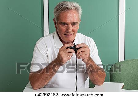 Old man playing videogames View Large Photo Image Stock Image - Old man playing videogames. Fotosearch