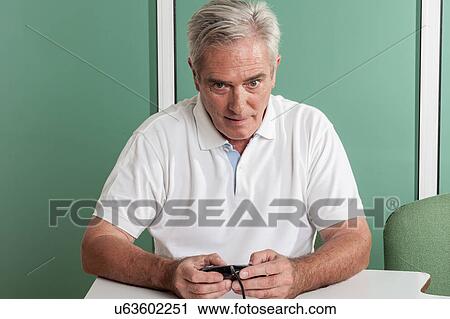 Old man playing videogames View Large Photo Image Stock Image - Old man playing videogames. Fotosearch