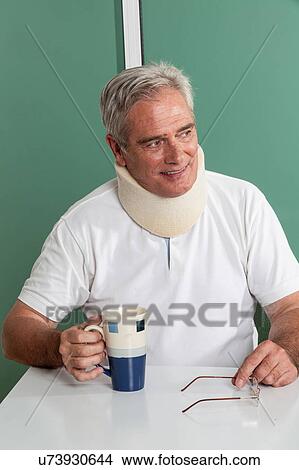 Picture - Old Man sitting having a breakfast. Fotosearch