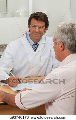 Stock Image - Old Man visiting the doctos. Fotosearch