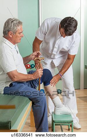 Stock Image - Old man with his doctor. Fotosearch