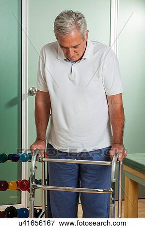 Stock Photo - Older man using a walker. Fotosearch