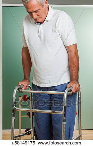 Older man using a walker View Large Photo Image Stock Photography - Older man using a walker. Fotosearch