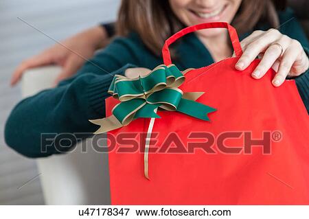 Stock Photo - Opening the gift. Fotosearch