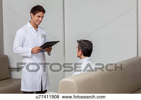 Stock Photo - Ophthalmologist and patient talking. Fotosearch