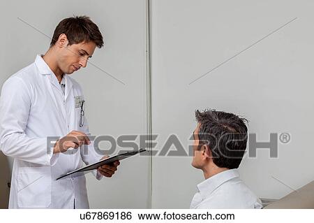 Stock Photograph - Ophthalmologist and patient talking. Fotosearch