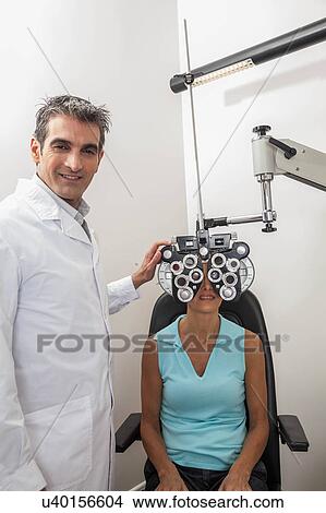 Picture - Ophthalmologist checking the eyes. Fotosearch