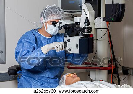Stock Image - Ophthalmologist checking the eyes. Fotosearch