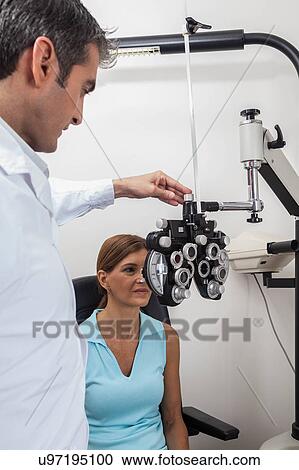 Stock Image - Ophthalmologist checking the eyes. Fotosearch