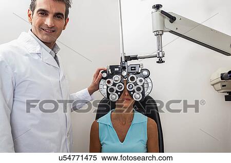 Ophthalmologist checking the eyes View Large Photo Image Stock Photography - Ophthalmologist checking the eyes. Fotosearch