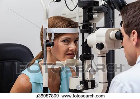 Stock Photo - Ophthalmologist doing studies. Fotosearch