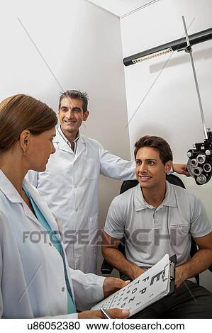 Stock Image - Ophthalmologist explaining. Fotosearch