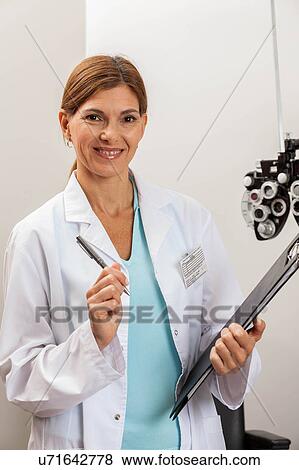 Ophthalmologist in his office View Large Photo Image Stock Photo - Ophthalmologist in his office. Fotosearch