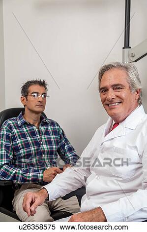 Stock Photography - Ophthalmologist looking at camera. Fotosearch