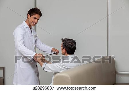 Stock Photo - Ophthalmologist meeting the patient. Fotosearch