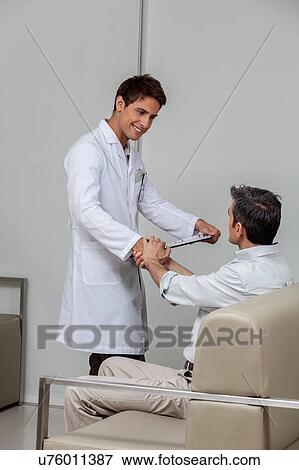 Stock Photo - Ophthalmologist meeting the patient. Fotosearch