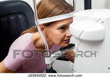 Stock Image - Ophthalmologist performing eye tests. Fotosearch