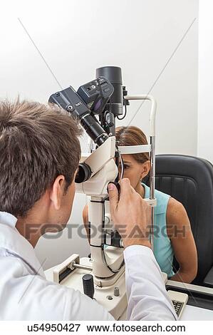 Ophthalmologist performing eye tests View Large Photo Image Stock Photo - Ophthalmologist performing eye tests. Fotosearch
