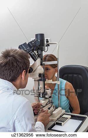 Stock Photograph - Ophthalmologist performing eye tests. Fotosearch