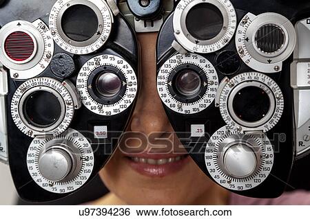 Stock Photograph - Ophthalmologist performing eye tests. Fotosearch