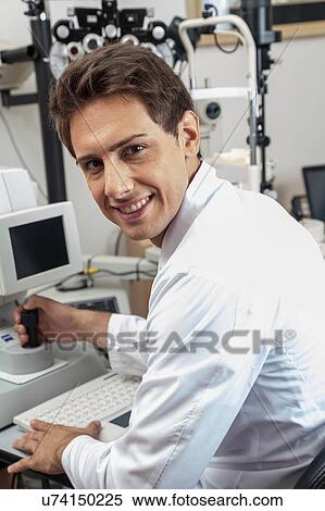 Stock Photography - Ophthalmologist performing eye tests. Fotosearch