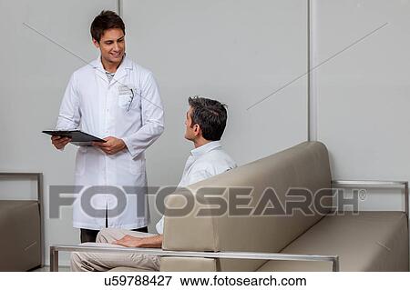 Stock Photo - Ophthalmologist talking with patient. Fotosearch