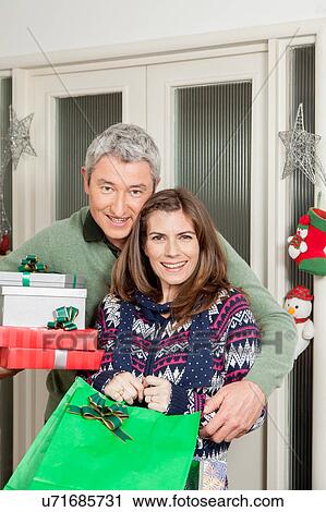Parents holding gifts View Large Photo Image Stock Image - Parents holding gifts. Fotosearch