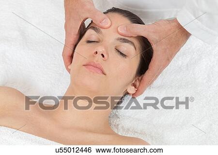 Stock Photograph - Peaceful woman getting a massage. Fotosearch