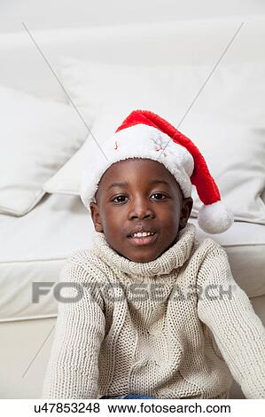 Stock Photo - Portrait of black boy on Christmas. Fotosearch