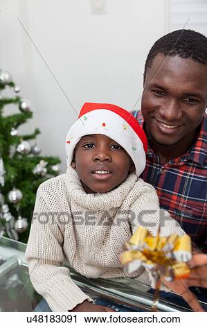 Stock Image - Portrait of father and son at Christmas. Fotosearch