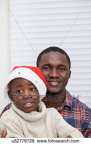 Stock Photo - Portrait of father and son at Christmas. Fotosearch