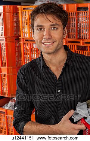 Stock Image - Portrait of man in the laundry. Fotosearch