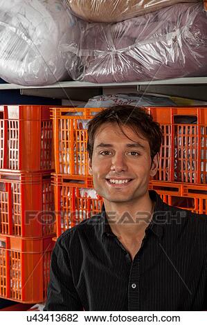 Stock Image - Portrait of man in the laundry. Fotosearch