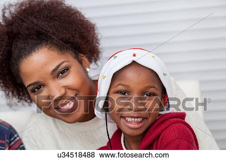 Stock Photo - Portrait of mother and daughter looking at camera. Fotosearch