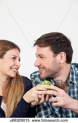 Stock Photography - Pretty couple having a breakfast. Fotosearch