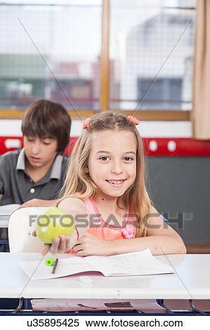 pretty girl giving a apple View Large Photo Image Stock Photography - pretty girl giving a apple. Fotosearch