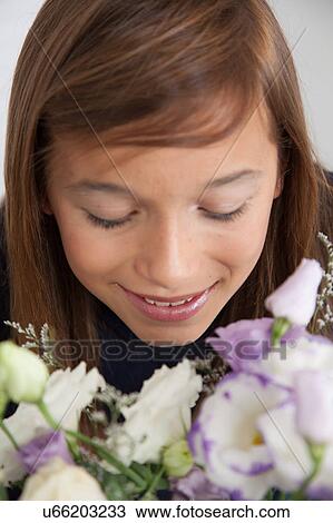 Stock Image - Pretty girl with flowers. Fotosearch