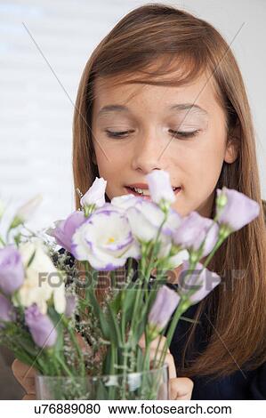 Stock Image - Pretty girl with flowers. Fotosearch