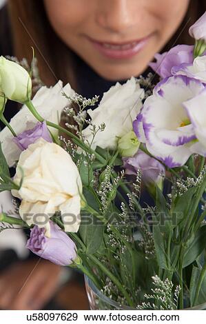 Stock Photo - Pretty girl with flowers. Fotosearch