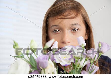 Stock Photo - Pretty girl with flowers. Fotosearch