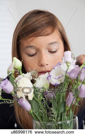 Stock Photograph - Pretty girl with flowers. Fotosearch