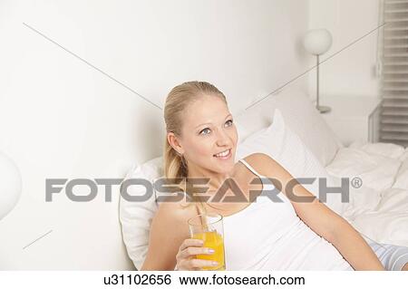 Pretty woman drinking a juice View Large Photo Image Stock Photograph - Pretty woman drinking a juice. Fotosearch