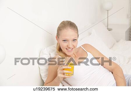 Pretty woman drinking a juice View Large Photo Image Stock Photography - Pretty woman drinking a juice. Fotosearch