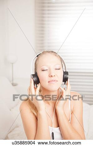 Pretty woman listening to music View Large Photo Image Picture - Pretty woman listening to music. Fotosearch