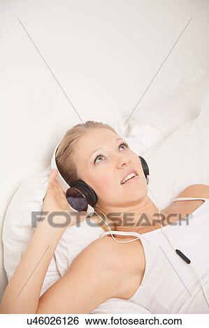 Pretty woman listening to music View Large Photo Image Stock Photograph - Pretty woman listening to music. Fotosearch