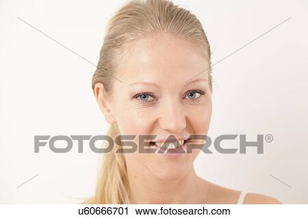 Stock Image - Pretty woman looking at camera. Fotosearch